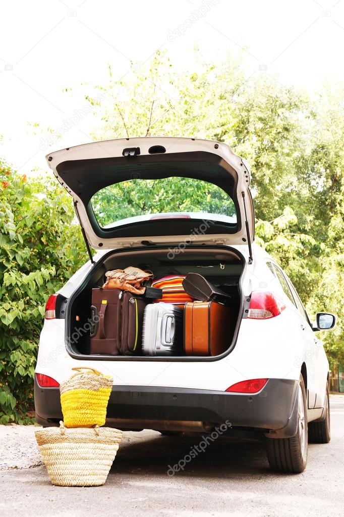 Suitcases and bags in trunk of car ready to depart for holidays