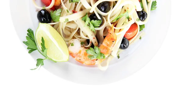 Fresh prawns with spaghetti, olives, tomatoes and parsley in a big round plate on white background isolated — Stock Photo, Image