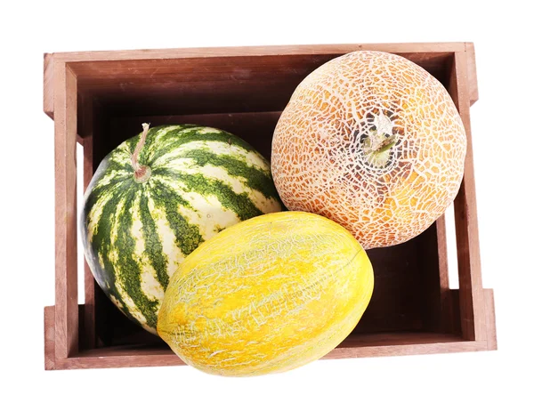 Melons and watermelons in wooden box isolated on white — Stock Photo, Image