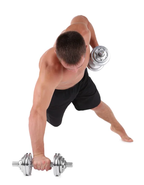 Guapo joven deportista muscular ejecutar ejercicio con mancuernas aisladas en blanco —  Fotos de Stock