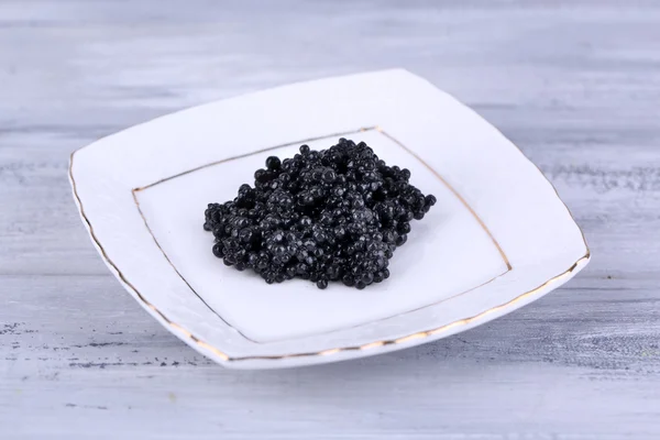 Black caviar on plate — Stock Photo, Image