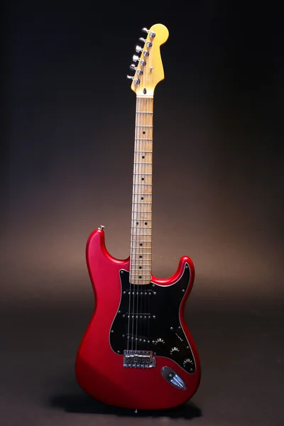 Red guitar on dark background — Stock Photo, Image