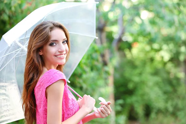 Beautiful young girl with umbrella outdoors — Stock Photo, Image