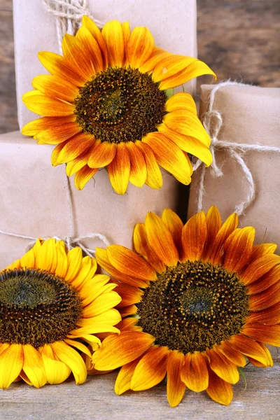 Sunflowers with present boxes on wooden background Stock Photo