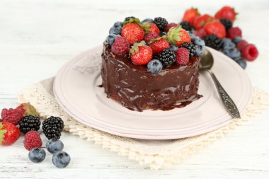 Tasty chocolate cake with different berries