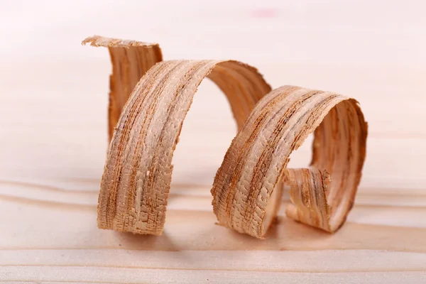 Wood shavings on wooden background — Stock Photo, Image