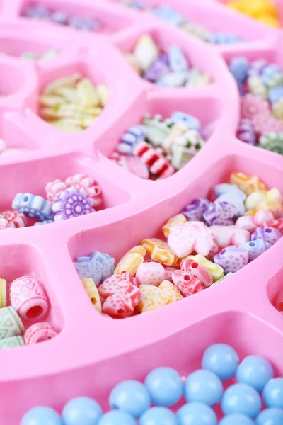 Multicoloured beading kit for children in a pink box — Stock Photo, Image