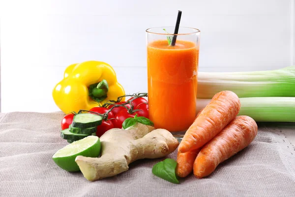 Vetro di succo di carota fresco e verdure su un tovagliolo — Foto Stock