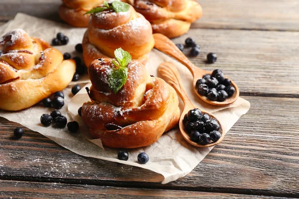 Tasty buns with berries on table close-up — Stock Photo, Image