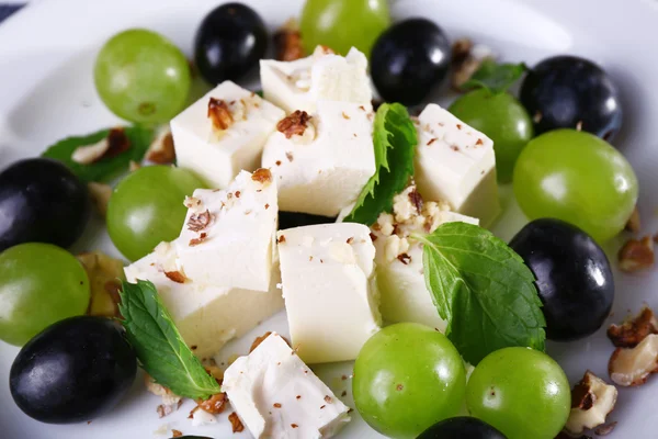 Tasty salad with grape and cheese, close up — Stock Photo, Image