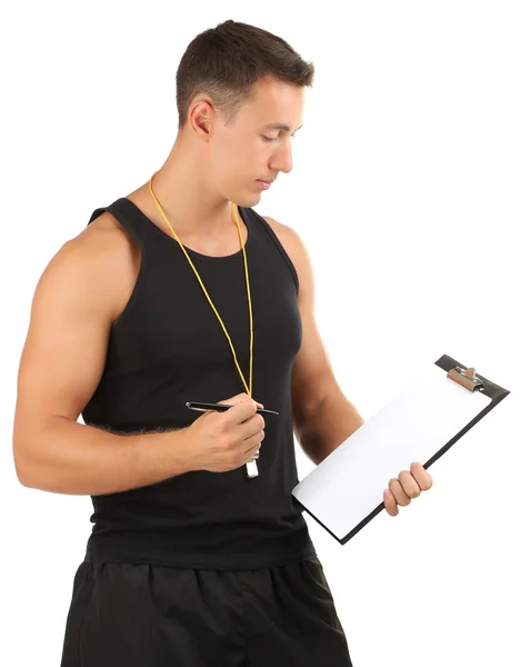 Handsome young sportsman holding clipboard isolated on white — Stock Photo, Image