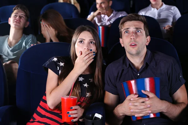 Young people watching movie in cinema Stock Picture
