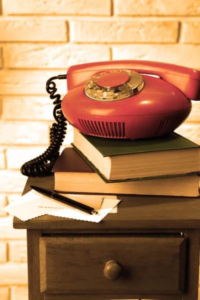Retro phone on nightstand in room — Stock Photo, Image