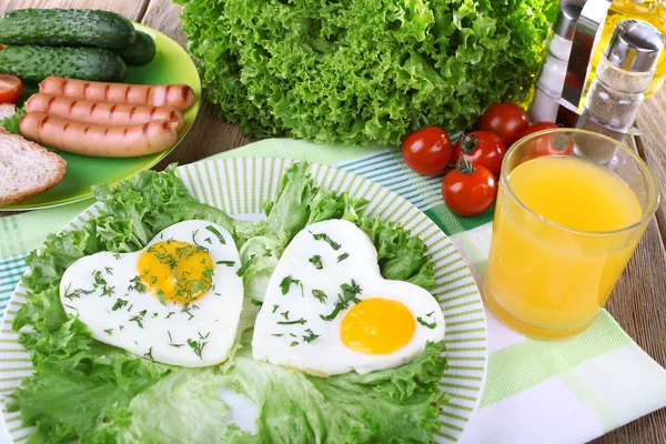 Scrambled eggs with sausage and vegetables served on plate on napkin