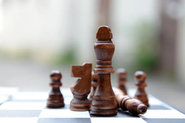 Chess board with chess pieces on light background — Stock Photo, Image