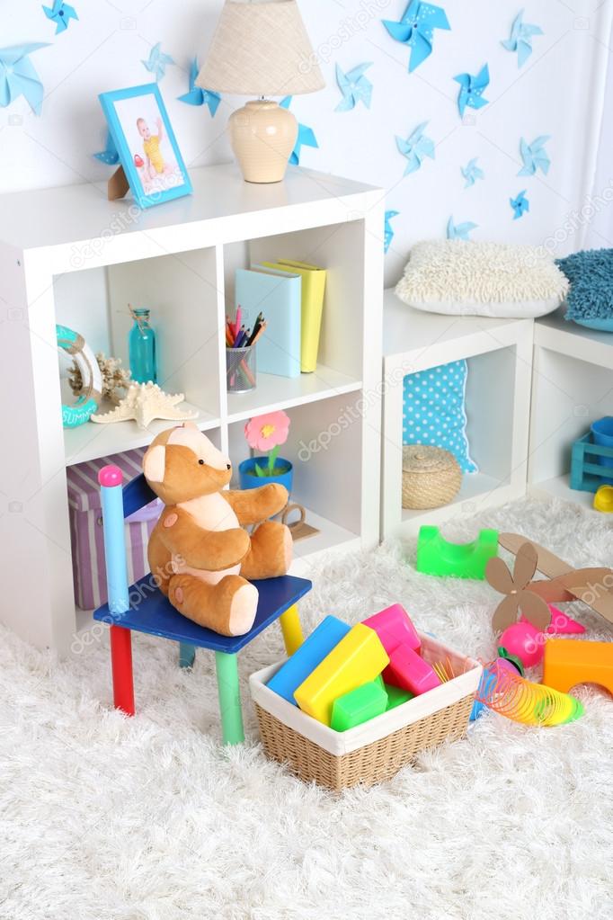 Colorful toys on fluffy carpet in children room