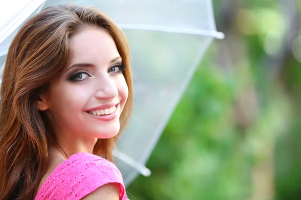 Beautiful young girl with umbrella outdoors — Stock Photo, Image