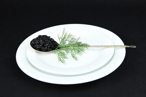 Colher com caviar preto na placa — Fotografia de Stock