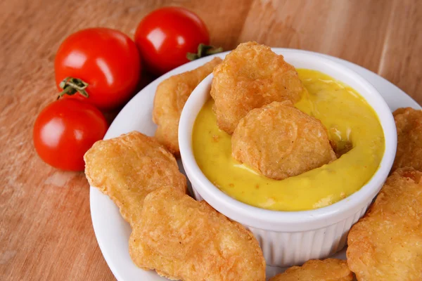 Chicken nuggets with sauce on table close-up — Stock Photo, Image