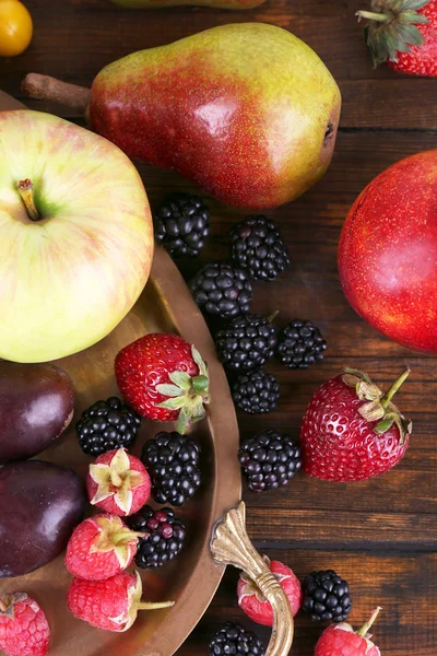 不同的浆果和水果对木桌特写镜头上的纸盒 — 图库照片