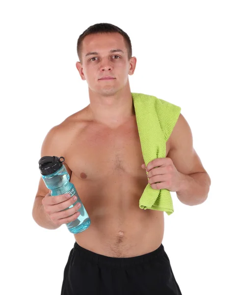 Handsome young sportsman holding towel and bottle with water isolated on white — Stock Photo, Image