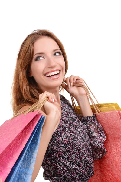 Beautiful young woman with shopping bags isolated on white — Stock Photo, Image