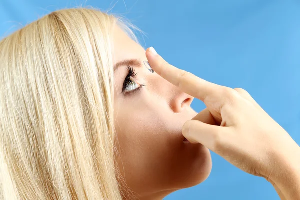 Medicine and vision concept - young woman with contact lens, close up — Stock Photo, Image