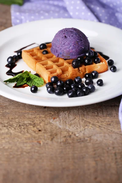 Tasty belgian waffles with ice cream on wooden table — Stock Photo, Image