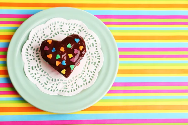 Delicious rainbow mini cake on paper napkin, on bright background — Stock Photo, Image