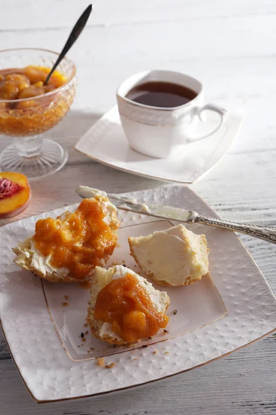 Light breakfast with cup of tea and homemade jam on wooden table — Stock Photo, Image