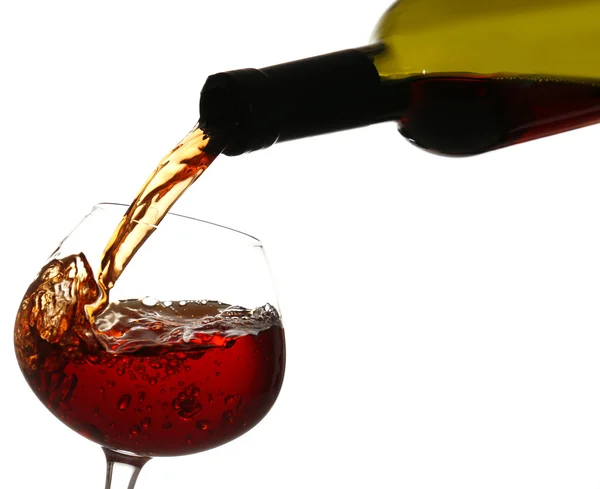 Red wine pouring into wine glass, isolated on white — Stock Photo, Image