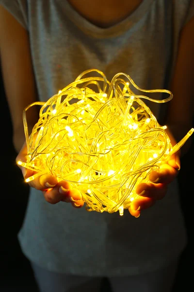 Woman holding yellow garland — Stock Photo, Image