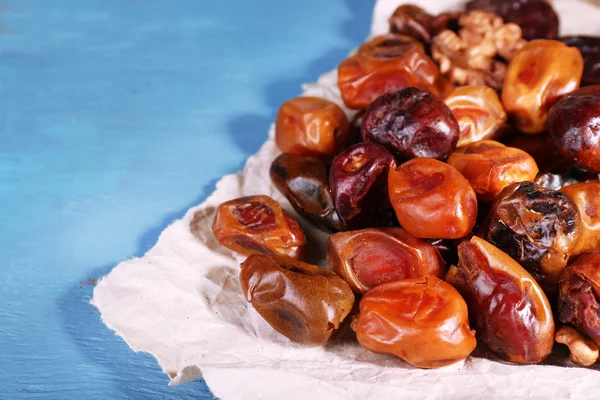 Tasty dates fruits on blue wooden table — Stock Photo, Image