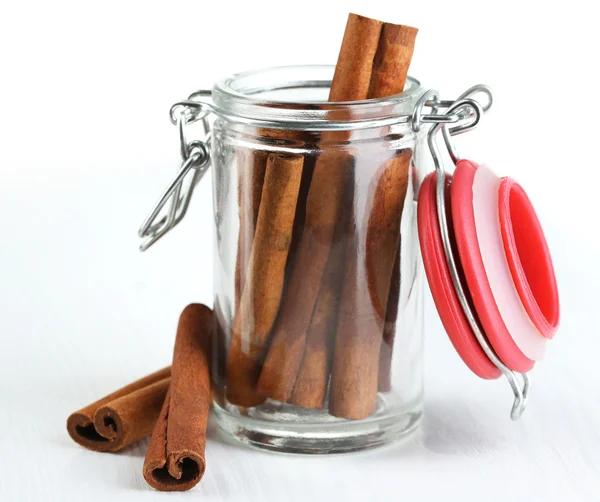 Cinnamon bark in glass bank on wooden table — Stock Photo, Image