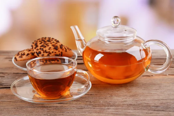 Teapot and cup of tea on table on light background — Stock Photo, Image