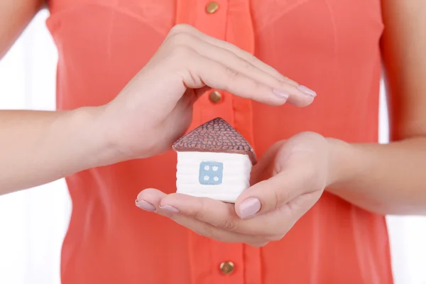 Woman hands holding small house — Stock Photo, Image