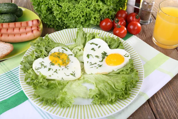 Huevos revueltos con salchichas y verduras servidas en plato sobre servilleta —  Fotos de Stock