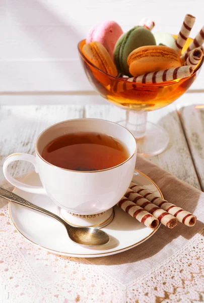 Cup of tea with macaroons on table, close up — Stock Photo, Image