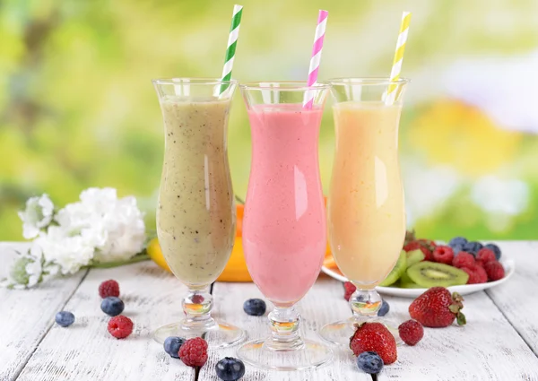 Köstliche Beerencocktails auf dem Tisch vor hellem Hintergrund — Stockfoto