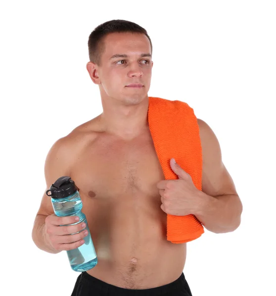 Handsome young sportsman holding towel and bottle with water isolated on white — Stock Photo, Image