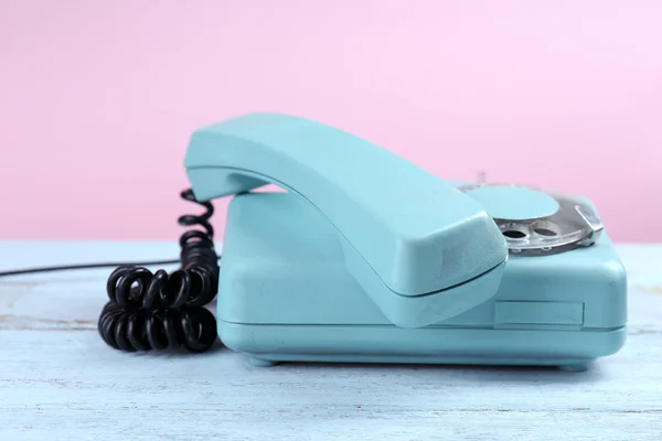 Retro turquoise telephone on wooden table, close up — Stock Photo, Image