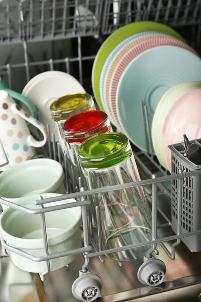 Open dishwasher with clean utensils in it — Stock Photo, Image