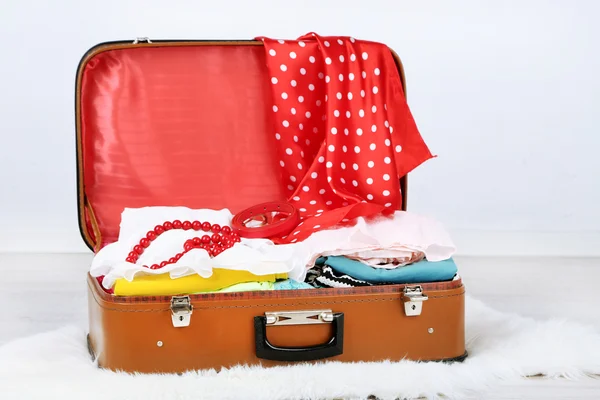 Clothes in old suitcase — Stock Photo, Image