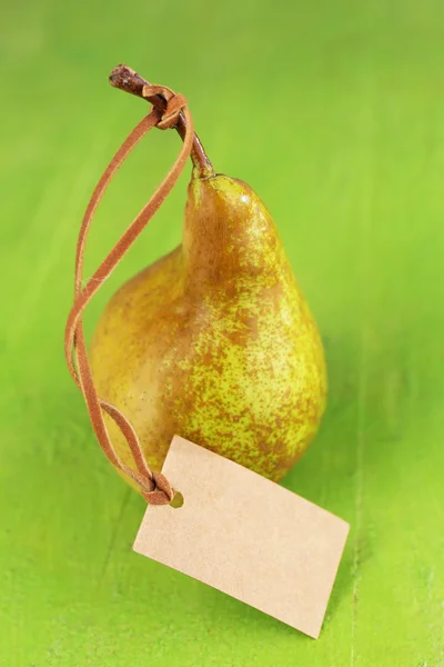 Ripe pear with tag — Stock Photo, Image