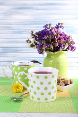 Cups with sugar and wildflowers clipart