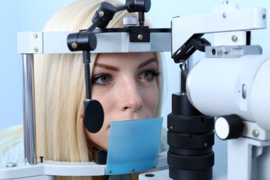 Woman having her eyes examined clipart