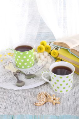 Tea with biscuits and books clipart