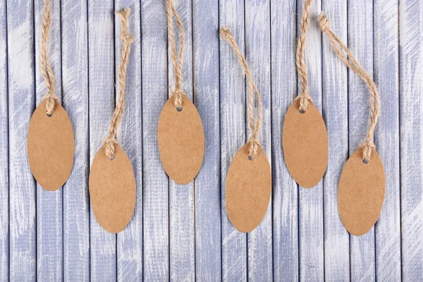 Brown tags on wooden background — Stock Photo, Image