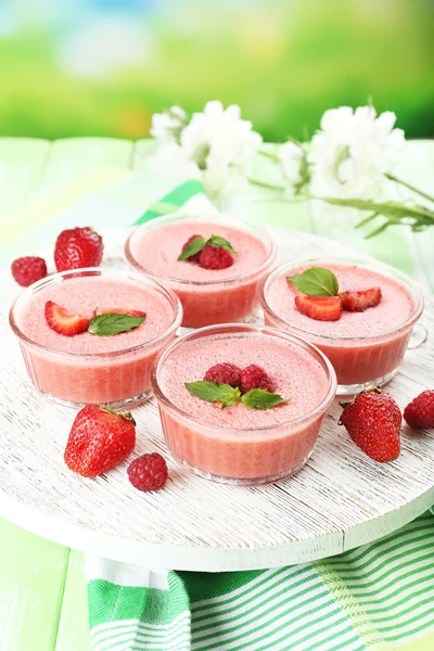 Delicious berry mousse in bowls on table on bright background — Stock Photo, Image