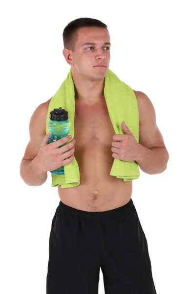 Handsome young sportsman holding towel and bottle with water isolated on white — Stock Photo, Image